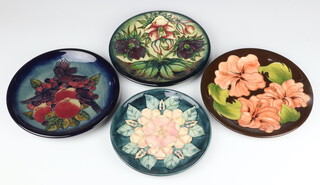 A Moorcroft Limited edition plate decorated "Tudor Rose" designed by Sally Tuffin, no.93/100, 22cm, decorated "Finches" designed by Sally Tuffin, 26cm, a plate decorated "Hellebore" designed by Nicola Slaney, dated '99 26cm (second),   another decorated "Hibiscus" impressed marks, 26cm 