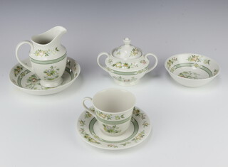 A 78 piece Royal Doulton Tonkin pattern dinner service comprising 9 tea cups, 9 saucers, 9 side plates, 4 sugar bowls, 1 lidded sugar bowl, milk jug,  soup cup, 8 soup bowls, 8 saucers, fruit saucer, dinner plate, cream jug, 1 coffee can, 1 saucer and a cake plate 