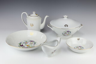 An 84 piece Limoges porcelain tea/dinner service comprising twin handled tureen and cover, shallow bowl, shallow dish, oval bowl, twin handled plate, 12 dinner plates, 12 soup bowls, 12 pudding bowls (1 cracked), 2 oval dishes, sauce boat, coffee cup, cream jug, lidded sugar bowl, coffee pot, 24 saucers (7 cracked and 1 with chip), 12 coffee cups, all decorated birds amidst branches and with monogram 