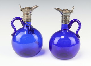 A pair of 19th Century Bristol blue glass ewers with plated mounts, 1 with a Brandy label 20cm 