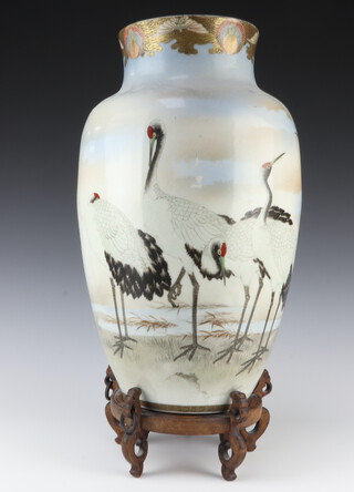 An early 20th Century Japanese oviform vase decorated with heron 46cm, blue 8 character mark to the base, with a wooden stand