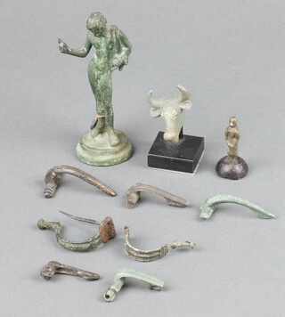 Seven Roman bronze Fibula brooches, a bronze seal, a Roman bronze figure of a standing gentleman 9cm, ditto bust of a bulls head 