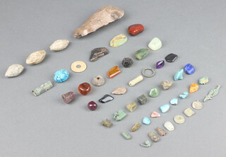 A Roman axe head and collection of various Roman and later sections of stone etc 