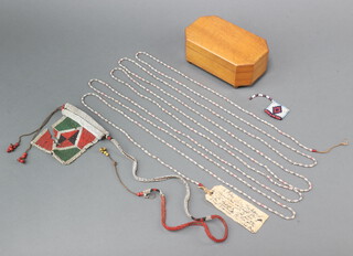 A bone Zulu necklace and a section of Zulu bead work, contained in a lozenge shaped oak box with hinged lid 