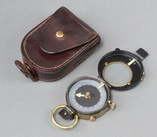 A Verners Patent VII prismatic compass with leather carrying case 