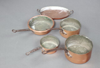 Three graduated copper saucepans with steel handles largest 22cm x 23cm, a frying pan and an oval twin handled dish 