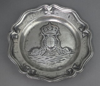 A 17th Century style embossed circular pewter dish with armorial decoration and bracketed border, the reverse with Tudor Rose mark 23cm x 40cm 