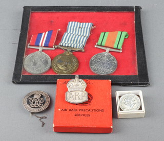 A First World War discharge badge no.B81724, a Second World War Kings discharge badge, an ARP badge in original cardboard box together with a Second World War British War medal, Defence medal and United Nations Korea medal (no bar), framed 