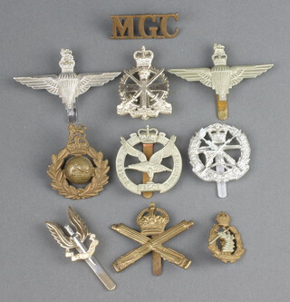 A Machine Gun Corps metal shoulder title, Royal Marines Cap badge, Glider Pilot Regt. Cap badge, 2 Parachute Regt. cap badges and 5 other badges