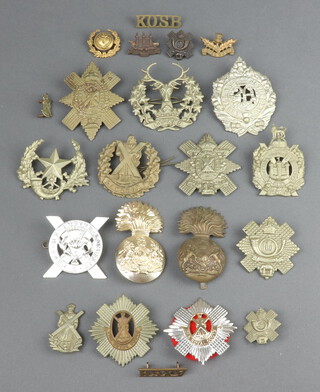 A Gordon Highlander's cap badge, an Argyle and Sutherland Highlander's cap badge and a collection of Scottish cap badges