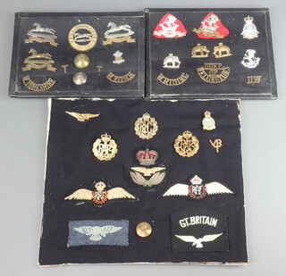 A Royal Flying Corps cap badge, a RAF Officer's cap badge, a pair of Royal Canadian Air Force Wings and other badges, a collection of Duke of Welling Regt. cap badges and West Yorkshire, all mounted