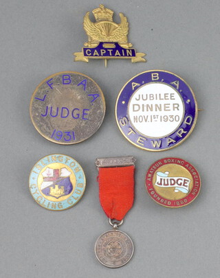 A 1930 Amateur Boxing Association Jubilee Dinner Steward's badge, a L.F.B.AA badge marked Judge 1931, an Amateur Boxing Association gilt metal and enamelled judges badge, an Islington Cycling Club enamelled badge, an enamelled cycling badge marked Captain and an Amateur Athletics Association miniature medal  