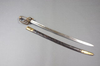 A Victorian dress sword with 74cm blade, the pierced gilt knuckle grip with armorial, complete with leather scabbard 