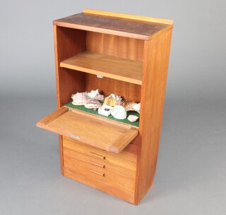 A teak cabinet with a recess fall front fitted 6 shallow drawers containing a collection of fossils 84cm h x 46cm w x 26cm d 