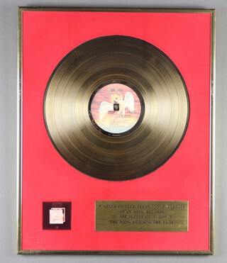 Led Zeppelin, a framed gold disc from Warner-Pioneer Japan, congratulating Swan Song Records in "On The Superlative Album The Song Remains The Same 1977"