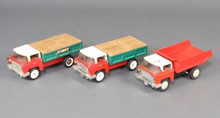 Triang Toys, 2 Highway Tipper Trucks, 2 Highway Flat Bed Trucks and 1 other Dump Truck, together with a collection of wooden building blocks