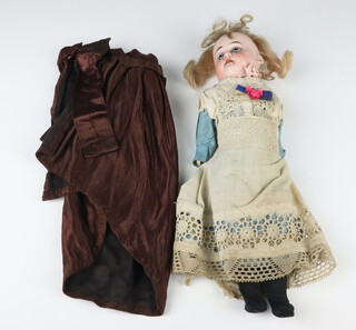 A Gebruder Knoch bisque doll, the head impressed 185 and with painted lashes, eye brows and lips, dressed in a satin cape, lace and turquoise dress and bonnet 