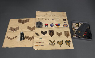 A collection of cloth military insignia including 2 lanyards and some American cloth insignia 