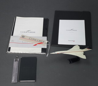 A collection of Concorde memorabilia including plastic model Concorde, luggage labels, diary, stationery 