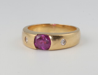 A yellow metal 18k ruby (treated) approx. 0.5ct and 2 stone diamond 0.04ct ring, size J 1/2, 5.5 grams