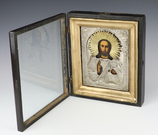 A late 19th Century Russian icon with white metal repousse oklad showing a figure of christ, framed 20cm x 17cm 