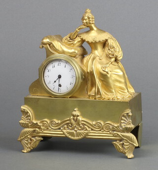 A 19th Century French table clock with watch movement having a ceramic dial, contained in a gilt metal case supported by a figure of a seated lady 15cm h x 14cm w x 2.5cm d, the movement signed Foucaux A Darent, complete with key  