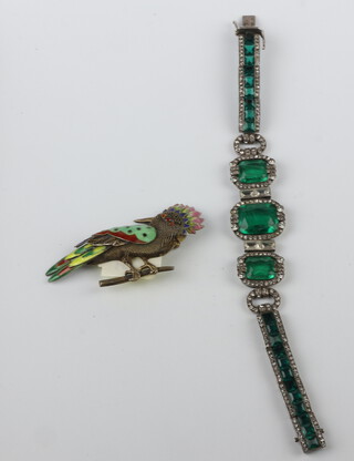 An Art Deco paste green and white stone bracelet together with an enamelled silver gilt bird brooch 