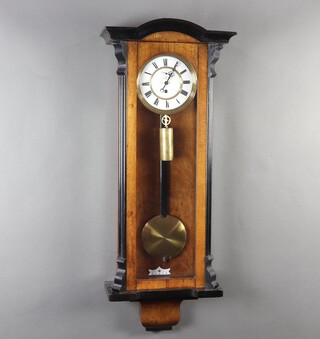 A Vienna style regulator with 16cm porcelain dial, Roman numerals, complete with pendulum and weight (no key), contained in walnut and ebonised case 39cm h x 38cm w x 17cm d 