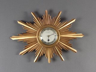 Mappin & Webb, a 1940's wall timepiece with 10cm silvered dial, Roman numerals, contained in a carved gilt wood sunburst case 47cm x 37cm 