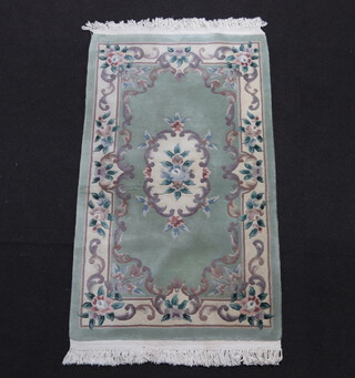 A green and floral patterned Chinese rug 153cm x 90cm 