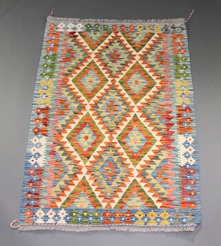 A white, orange and turquoise ground Chobi Kilim with diamond design to the centre 146cm x 106cm 