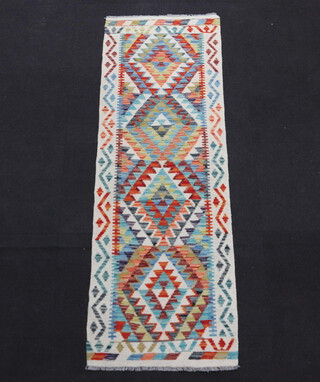 A white turquoise and green ground Chobi Kilim runner with 4 diamonds to the centre 202cm x 69cm 