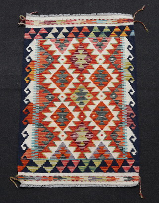 A brown, white and black ground Chobi Kilim rug with all over geometric design 90cm x 60cm 