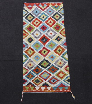 A white, turquoise and green ground Chobi Kilim runner with diamond design 147cm x 65cm 