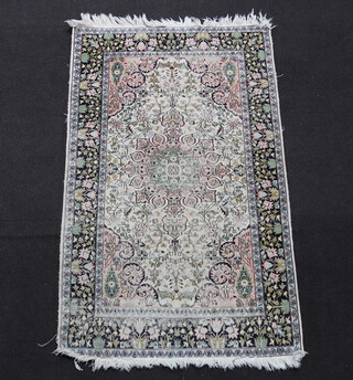 A white and blue ground  North Persian floral patterned silk rug with central medallion within a 3 row border 157cm x 97cm 