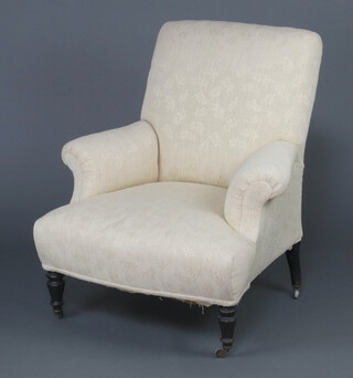 A Victorian armchair upholstered in oatmeal coloured material, raised on ebonised turned supports 84cm h x 74cm w x 62cm d (seat 26cm x 31cm) 