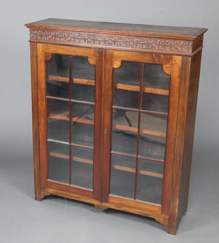 An Edwardian mahogany display cabinet with blind fret work frieze,  fitted adjustable shelves enclosed by astragal glazed panelled doors 107cm h x 91cm w x 28cm d 