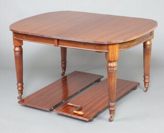 A Victorian mahogany extending dining table with 2 extra leaves, raised on turned and reeded supports 74cm h x 106cm w x 135cm l x 209cm l when extended, complete with winder 