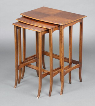 A nest of 3 Edwardian  quarter veneered bow front coffee tables with ebonised stringing 68cm h x 53cm w x 36cm d 