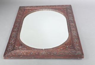 A Victorian oval bevelled plate wall mirror contained in a carved oak frame 103cm x 71cm  