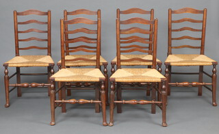 A set of 6 1920's elm ladder back dining chairs with woven rush seats, raised on turned supports 93cm h x 51cm w x 36cm d (seats 25cm x 23cm) 