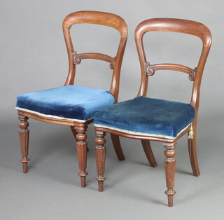 A pair of Victorian mahogany spoon back chairs with arch shaped mid rails and over stuffed seats, raised on reeded supports 87cm h x 49cm w x 45cm d 