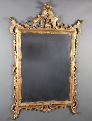 A Rococo style rectangular plate mirror contained in a carved and gilt painted wooden frame 127cm h x 85cm 