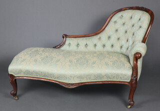 A Victorian carved rosewood show frame chaise longue upholstered in green buttoned material, raised on cabriole supports 87cm h x 129cm w x 59cm d 