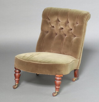 A Victorian nursing chair upholstered in green buttoned material, raised on turned supports 67cm h x 56cm w x 52cm d (seat 31cm x 28cm) 