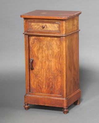 A Continental walnut bedside cabinet fitted a drawer above cupboard enclosed by panelled doors, raised on bun feet 81cm h x 42cm w x 35cm d 