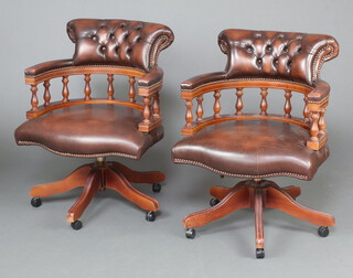 A pair of beech framed revolving Captain style office chairs with spindle decoration 79cm h x 62cm w x 56cm d (seat 39cm x 35cm) 