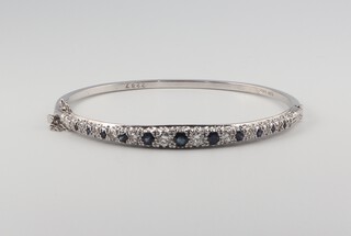 A white metal 18ct sapphire and diamond bangle set with 12 brilliant cut diamonds approx. 0.4ct and sapphires 0.20ct, 15.4 grams