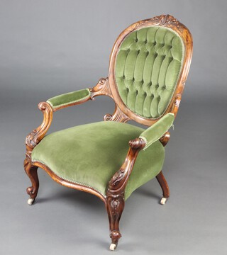 A Victorian mahogany show frame open arm chair, the seat of serpentine outline, upholstered in green buttoned material, raised on cabriole supports 98cm h x 65cm w x 57cm d (seat 30cm x 40cm) 