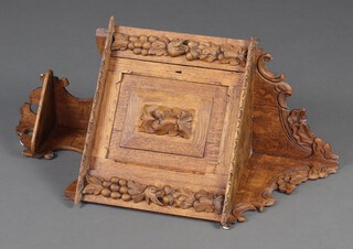 A Victorian carved light oak hanging corner cabinet with shelf and niche enclosed by a panelled door with lion mask 80cm h x 44cm w x 37cm d 